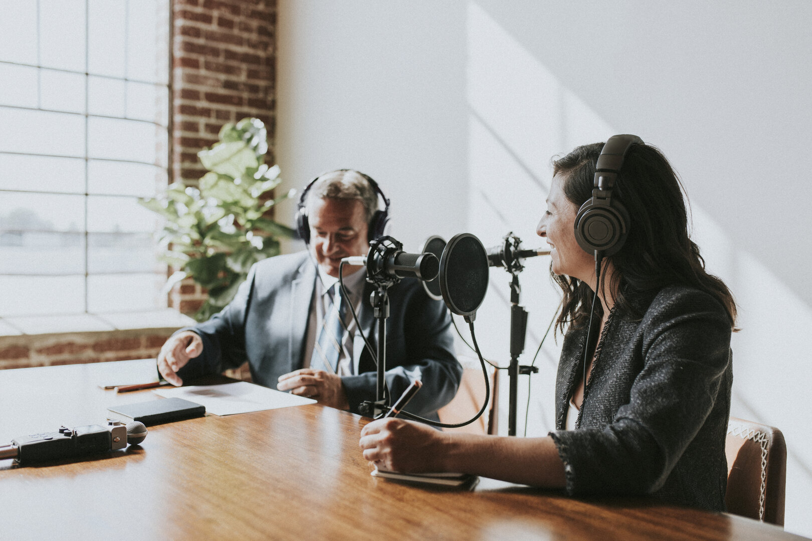 Female broadcaster interviewing her guest in a studio